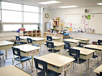 Arial shot of a classroom with desks lined up.