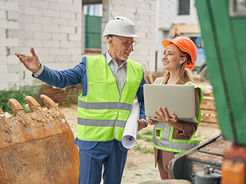 Man and woman at a construction site talking