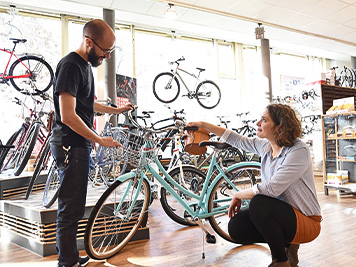 Bicycle shop consulting - salesman and customer in conversation 
