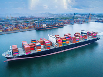 Aerial top view containers ship cargo business commercial trade logistic and transportation of international import export by container freight cargo ship in the open seaport.